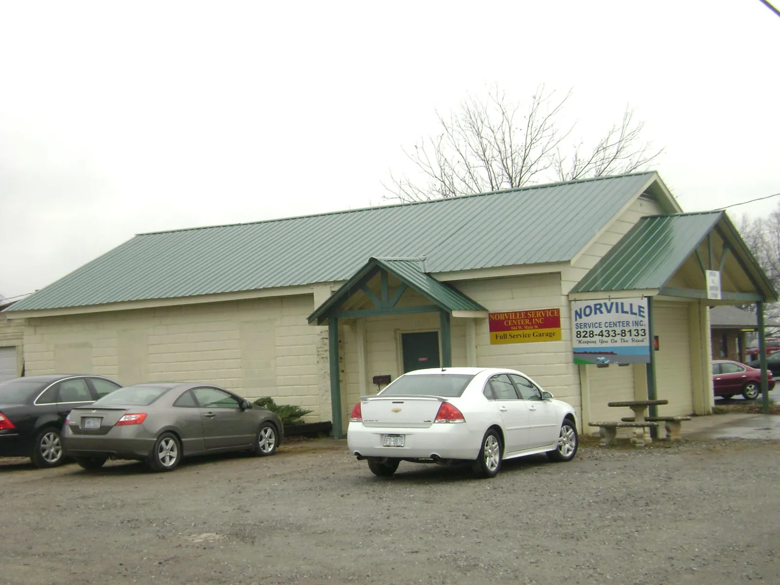 Green metal roof on a service garage with a covered entry in Mooresville
