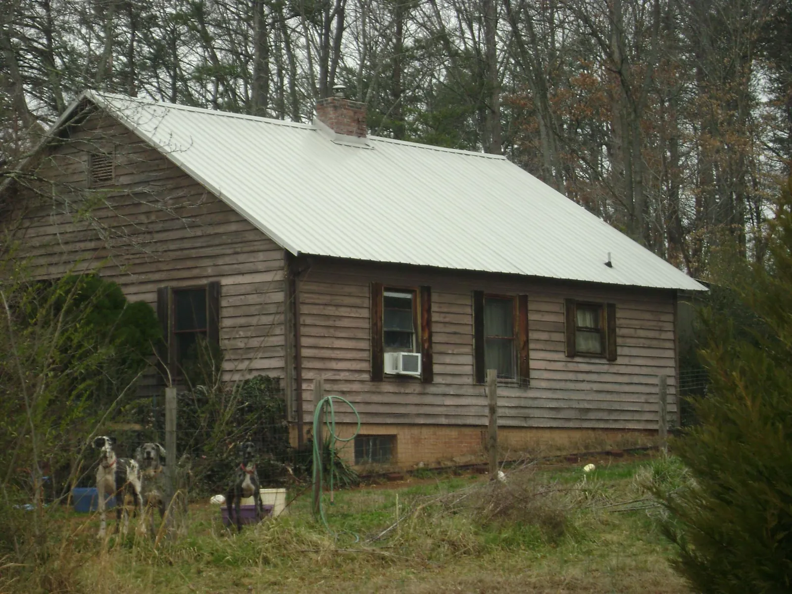 White metal roof on an old wood sided farmhouse, from a Asphalt Shingle Roof Repair job in Mooresville